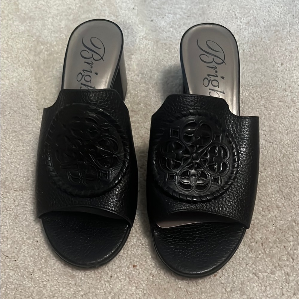 Brighton Black Leather Mules with Embossed Medallion
